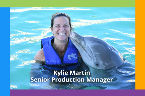 Kylie Martin smiles with a dolphin, highlighting her role as Senior Production Manager at PMG. Welcoming her to Nonprofit Direct Mail Production.