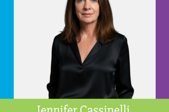 professional headshot of a woman in a black, long-sleeved blouse.
