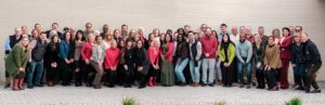 Large group of smiling PMG employees.