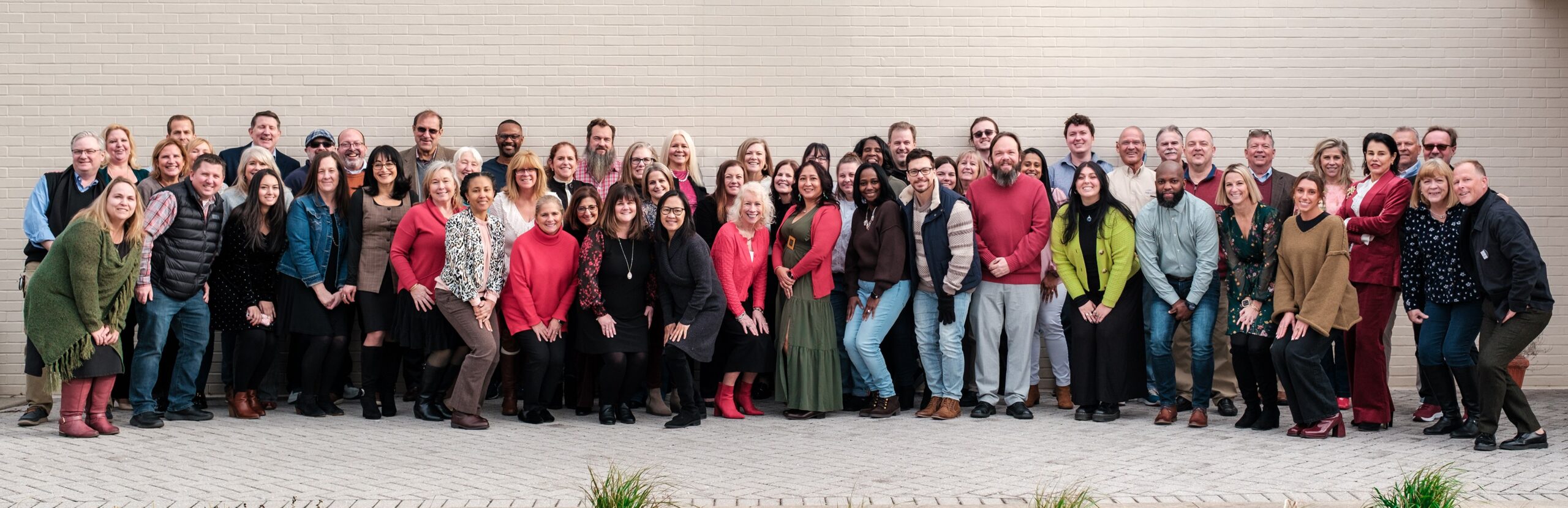 Large group of smiling PMG employees.